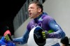 Britain's Matt Weston reacts as he arrives at the finish during a men's skeleton run at the 2026 Winter Olympics, in Cortina d'Ampezzo, Italy, Friday, Feb. 13, 2026. (AP Photo/Alessandra Tarantino)