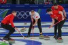 Switzerland's Yannick Schwaller, Pablo Lachat-Couchepin, Benoît Schwarz-van Berkel and Canada's Brad Jacobs in action during the men's curling round robin session at the 2026 Winter Olympics in Cortina d'Ampezzo, Italy on Feb. 14, 2026. (AP Photo/Fatima Shbair)