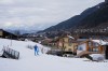 A cross-country skiing athlete from Italy skis through the village of Ziano di Fiemme during a non-competition day at the 2026 Winter Olympics, near the course in Tesero, Italy, Monday, Feb. 9, 2026. (AP Photo/Armando Franca)
