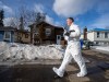 A police investigator leaves the home where two bodies were found in Tumbler Ridge, B.C., on Thursday, Feb. 12, 2026. THE CANADIAN PRESS/Christinne Muschi