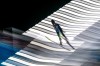 Ilya Mizernykh, of Kazakhstan, soars through the air during his trial jump of the ski jumping men's super team competition at the 2026 Winter Olympics, in Predazzo, Italy, Monday, Feb. 16, 2026. (AP Photo/Evgeniy Maloletka)