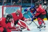 Ella Shelton (17) of Team Canada and Tessa Janecke (22) of Team United States battle in front of goaltender Ann-Renee Desbiens (35) during second period Olympic hockey action at the 2026 Milan Cortina Winter Olympics in Milan, Italy on Tuesday, Feb. 10, 2026. THE CANADIAN PRESS/Nathan Denette