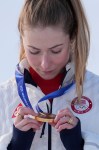 United States' Mikaela Shiffrin looks at her gold medal in an alpine ski, women's slalom race, at the 2026 Winter Olympics, in Cortina d'Ampezzo, Italy, Wednesday, Feb. 18, 2026. (AP Photo/Jacquelyn Martin)