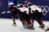 Kim Boutin of Canada pushes off to teammate Danae Blais for Team Canada during the women's 3000m relay short track speedskating at the 2026 Winter Olympics, in Milan, Italy, Saturday, Feb. 14, 2026. (AP Photo/Ashley Landis)