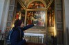 Sara Cainarca, a volunteer with the “La Via della Bellezza,” or “The Path of Beauty,” initiative, gestures toward a fresco inside the Basilica of San Lorenzo Maggiore in Milan, Italy, Wednesday, Feb. 18, 2026. (AP Photo/María Teresa Hernández)