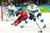 Canada forward Macklin Celebrini (17) tries to take the puck from Finland defenceman Niko Mikkola (77) during first period Men's Olympic semi final ice hockey action at the 2026 Milan Cortina Winter Olympics in Milan, Friday, Feb. 20, 2026. THE CANADIAN PRESS/Nathan Denette