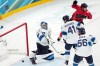 Canada's Brad Marchand (63) celebrates after teammate Shea Theodore scored against Finland goalkeeper Juuse Saros (74) during the third period of a men's ice hockey semifinal game at the 2026 Winter Olympics in Milan, Italy, Friday, Feb. 20, 2026. (AP Photo/Carolyn Kaster)