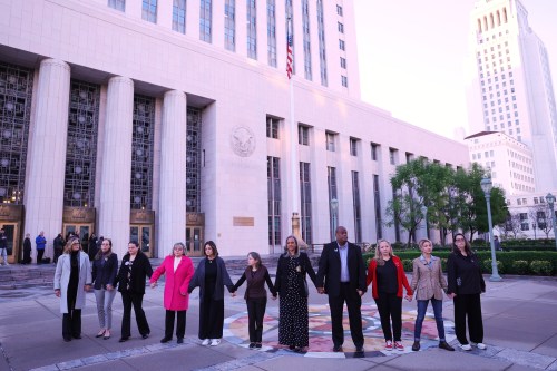 FILE - A group holds hands outside a landmark trial over whether social media platforms deliberately addict and harm children, Wednesday, Feb. 18, 2026, in Los Angeles. (AP Photo/Ryan Sun, File)