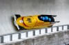 Germany's Johannes Lochner, left, Thorsten Margis, Jorn Wenzel and Georg Fleischauer slide down the track during a four man bobsled run at the 2026 Winter Olympics, in Cortina d'Ampezzo, Italy, Sunday, Feb. 22, 2026. (AP Photo/Alessandra Tarantino)