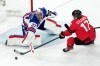United States goalkeeper Connor Hellebuyck (37) blocks a shot by Canada's Macklin Celebrini (17) during the third period of the men's ice hockey gold medal game at the 2026 Winter Olympics in Milan, Italy, Sunday, Feb. 22, 2026. (AP Photo/Carolyn Kaster)