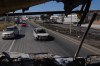Vehicles pass a burned car a day after the Mexican army killed Jalisco New Generation Cartel leader Nemesio Oseguera Cervantes, known as 