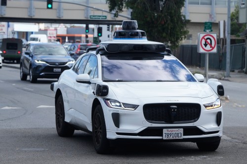 FILE - A Waymo vehicle drives past a No U-Turn sign in San Bruno, Calif., Tuesday, Sept. 30, 2025. (AP Photo/Jeff Chiu, File)