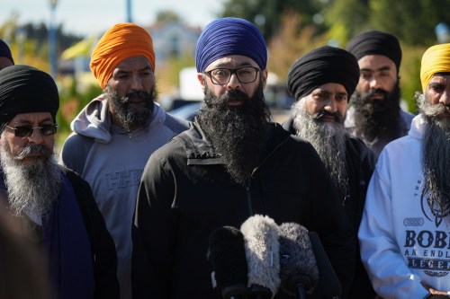 Moninder Singh, centre, a spokesperson for the British Columbia Gurdwaras Council (BCGC), speaks to reporters outside the Guru Nanak Sikh Gurdwara Sahib in Surrey, B.C., on Monday, Sept. 18, 2023, where temple president Hardeep Singh Nijjar was gunned down in his vehicle while leaving the parking lot. THE CANADIAN PRESS/Darryl Dyck