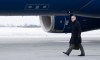 Prime Minister Mark Carney boards a government plane in Ottawa on Monday, Jan. 5, 2026. THE CANADIAN PRESS/Christinne Muschi