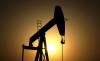 FILE- In this Wednesday, June 8, 2011 file photo, sun sets behind an oil pump in the desert oil fields of Sakhir, Bahrain. (AP Photo/Hasan Jamali, File)