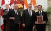 Prime Minister Mark Carney and Indian Prime Minister Narendra Modi look on as Saskatchewan Premier Scott Moe, centre, Cameco president Tim Gitzel, left, and High Commissioner of India to Canada Shri Patnaik participate in a presentation of agreements in New Delhi, India on Monday, March 2, 2026.  THE CANADIAN PRESS/Adrian Wyld