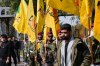 Members of an Iraqi Shiite militant group attend a funeral of a fighter of the Kataib Hezbollah, who was killed in a U.S. airstrike, in Baghdad, Iraq, Monday, March 2, 2026. (AP Photo/Hadi Mizban)