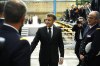 French President Emmanuel Macron with members of the army at the end of his speech at the Nuclear submarines Navy base of Ile Longue in Crozon, France, Monday March 2, 2026. (Yoan Valat/Pool Photo via AP)