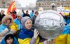 A pro-Ukrainian demonstrator holds a helmet with pictures of deceased Ukrainian athletes during a rally on Parliament Hill in Ottawa, on Sunday, Feb. 22, 2026. The helmet replicates one worn by Ukrainian skeleton racer Vladyslav Heraskevych who was disqualified during the 2026 Olympic Winter Games. THE CANADIAN PRESS/Spencer Colby